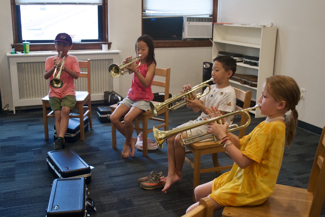 Students in Sound Safari learn to play the trumpet